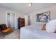 A cozy bedroom with a modern bed frame, dresser, and walk-in closet providing ample space at 1125 Sun Springs Rd, Wake Forest, NC 27587