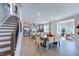 Open-concept dining area with modern lighting, seating for six, and stairs to second story at 1125 Sun Springs Rd, Wake Forest, NC 27587