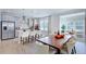 Modern kitchen and dining area features stainless steel appliances and a large wooden dining table at 1125 Sun Springs Rd, Wake Forest, NC 27587