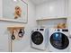 Bright laundry room with white cabinets and modern appliances at 1125 Sun Springs Rd, Wake Forest, NC 27587