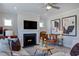 Cozy living room showcasing a fireplace, leather chair and modern abstract art at 1125 Sun Springs Rd, Wake Forest, NC 27587