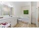 Bright bathroom featuring double vanity, soaking tub and separate shower at 1176 Stoney Mountain Rd, Rougemont, NC 27572