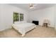 Bright bedroom with carpet, ceiling fan, and double bed in neutral color palette at 1176 Stoney Mountain Rd, Rougemont, NC 27572