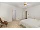 Bedroom with carpet and ceiling fan; two doors leading to other rooms at 1176 Stoney Mountain Rd, Rougemont, NC 27572