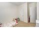 Cozy bedroom featuring neutral walls, carpet, and two doors for closet and entry at 1176 Stoney Mountain Rd, Rougemont, NC 27572