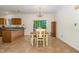 Bright dining area featuring tile floors, a wooden table, a charming chandelier, and sliding glass doors to patio at 1176 Stoney Mountain Rd, Rougemont, NC 27572