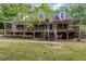Charming two-story home with a covered porch and landscaped front yard surrounded by lush trees at 1176 Stoney Mountain Rd, Rougemont, NC 27572