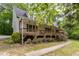 Charming home featuring a covered porch, landscaped yard, and lush greenery for a serene curb appeal at 1176 Stoney Mountain Rd, Rougemont, NC 27572