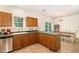 Kitchen with wood cabinets, green countertops, tile flooring and a connecting dining area at 1176 Stoney Mountain Rd, Rougemont, NC 27572