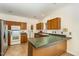 Traditional-style kitchen featuring wooden cabinets, tile floors, and white appliances at 1176 Stoney Mountain Rd, Rougemont, NC 27572