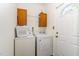 Functional laundry room with washer, dryer, and storage cabinet at 1176 Stoney Mountain Rd, Rougemont, NC 27572