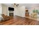 Spacious living area featuring a fireplace, hardwood floors, and open layout to kitchen at 1176 Stoney Mountain Rd, Rougemont, NC 27572