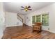 Bright living room featuring hardwood floors, ceiling fan, and large windows with views of the outdoors at 1176 Stoney Mountain Rd, Rougemont, NC 27572