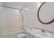 Bright bathroom featuring a shower-tub, neutral tile, large decorative mirror and elegant marble-topped vanity at 1217 Manassas Ct # H, Raleigh, NC 27615