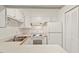 Cozy kitchen with white appliances and cabinets offer a quaint space to cook at 1217 Manassas Ct # H, Raleigh, NC 27615