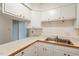 Kitchen with white cabinets, countertops and stainless steel sink at 1217 Manassas Ct # H, Raleigh, NC 27615