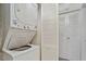 Laundry area features a stackable washer and dryer set next to some storage space at 1217 Manassas Ct # H, Raleigh, NC 27615