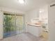 Bright living room with sliding glass doors to the outside and adjacent eat in kitchen at 1217 Manassas Ct # H, Raleigh, NC 27615