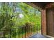 Relax on this patio with a black iron railing and wooded view, perfect for enjoying nature at 1217 Manassas Ct # H, Raleigh, NC 27615