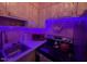 This vibrant kitchen includes pink cabinets, purple LED lights, and stainless steel appliances at 124 Fidelity St # Apt 27, Carrboro, NC 27510