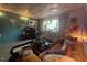 Comfortable living room with a neutral sofa, exposed brick, and large windows at 124 Fidelity St # Apt 27, Carrboro, NC 27510