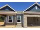 New home construction showing gray siding, brick accents, and a two-car garage, reflecting modern design at 136 N Keatts Winner Ct, Clayton, NC 27520