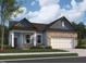 Charming single-Gathering home featuring a brick and light blue siding exterior with an attached two-car garage at 136 N Keatts Winner Ct, Clayton, NC 27520