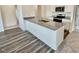 Open-concept kitchen featuring a center island with granite countertops, blending style and functionality at 136 N Keatts Winner Ct, Clayton, NC 27520