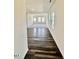 Open-concept living room features wood-look floors, bright white walls, and large windows at 136 N Keatts Winner Ct, Clayton, NC 27520
