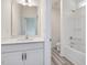 Bright bathroom features a white vanity with quartz countertop and a tub/shower combo with white surround at 149 Whimbrel Ct, Lillington, NC 27546