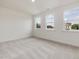 Bright bedroom with three windows and plush neutral carpeting at 149 Whimbrel Ct, Lillington, NC 27546