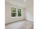 Bright room featuring two large windows and wood-look flooring at 149 Whimbrel Ct, Lillington, NC 27546