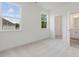 Bright bedroom with carpet, two windows, and doorway to bathroom with white vanity and mirror at 149 Whimbrel Ct, Lillington, NC 27546