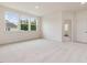 Bonus room featuring plush carpeting, three windows, and an open doorway to an adjacent room at 149 Whimbrel Ct, Lillington, NC 27546