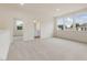 Large bonus room with neutral carpet, large windows and ensuite bathroom at 149 Whimbrel Ct, Lillington, NC 27546