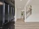 View of the entryway featuring a black front door, light wood floors, and a staircase with white railings at 149 Whimbrel Ct, Lillington, NC 27546
