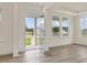 Bright entryway featuring an open door, large windows, and light wood floors at 149 Whimbrel Ct, Lillington, NC 27546