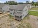 New construction home with gray siding, screened-in porch, and unfinished backyard space at 149 Whimbrel Ct, Lillington, NC 27546