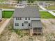 New construction home with gray siding, screened-in porch, and unfinished backyard space at 149 Whimbrel Ct, Lillington, NC 27546