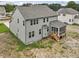 New construction home with gray siding, screened-in porch, and unfinished backyard space at 149 Whimbrel Ct, Lillington, NC 27546