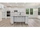 Modern kitchen with white cabinets, center island, and stainless steel appliances at 149 Whimbrel Ct, Lillington, NC 27546