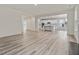 Open-concept living room with kitchen view featuring modern finishes at 149 Whimbrel Ct, Lillington, NC 27546