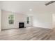 Bright living room with a fireplace and two windows offering natural light at 149 Whimbrel Ct, Lillington, NC 27546