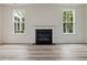 Living room features modern gas fireplace flanked by two windows at 149 Whimbrel Ct, Lillington, NC 27546