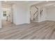 Open-concept space featuring light wood floors and a staircase with white railings at 149 Whimbrel Ct, Lillington, NC 27546