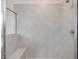 Elegant walk-in shower with neutral gray tiling and a built-in bench at 149 Whimbrel Ct, Lillington, NC 27546