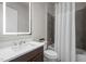 Modern bathroom featuring a single sink vanity, gray tiled shower, and a toilet with a white curtain at 1620 Hasentree Villa Ln, Wake Forest, NC 27587
