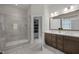 Elegant bathroom featuring a tiled walk-in shower and a double vanity at 1620 Hasentree Villa Ln, Wake Forest, NC 27587
