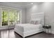 Bright bedroom with hardwood floors, tray ceiling, and a large window with a scenic view at 1620 Hasentree Villa Ln, Wake Forest, NC 27587