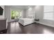 Bright bedroom with hardwood floors and a large window offering a scenic view at 1620 Hasentree Villa Ln, Wake Forest, NC 27587
